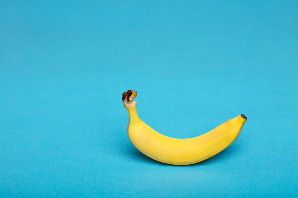 yellow banana fruit on blue surface